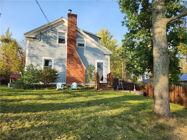 rear view of house with a lawn