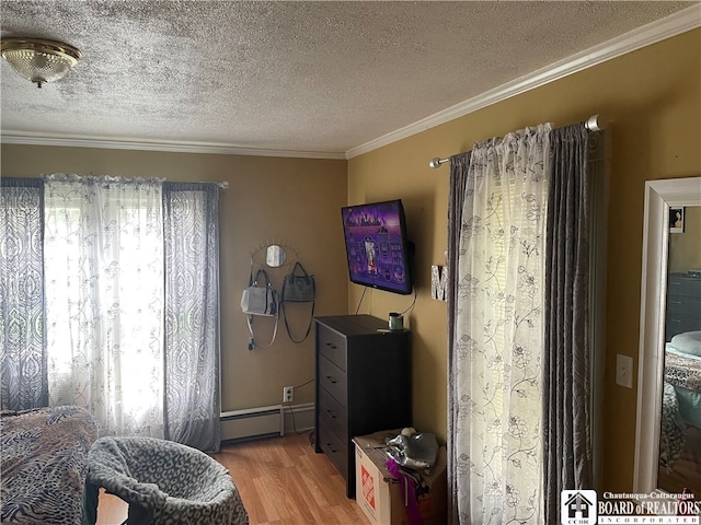 sitting room featuring wood-type flooring, crown molding, a baseboard heating unit, and a textured ceiling