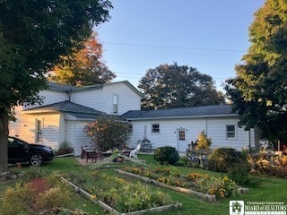 rear view of property with a yard