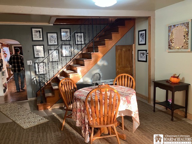 dining area with beamed ceiling and hardwood / wood-style floors