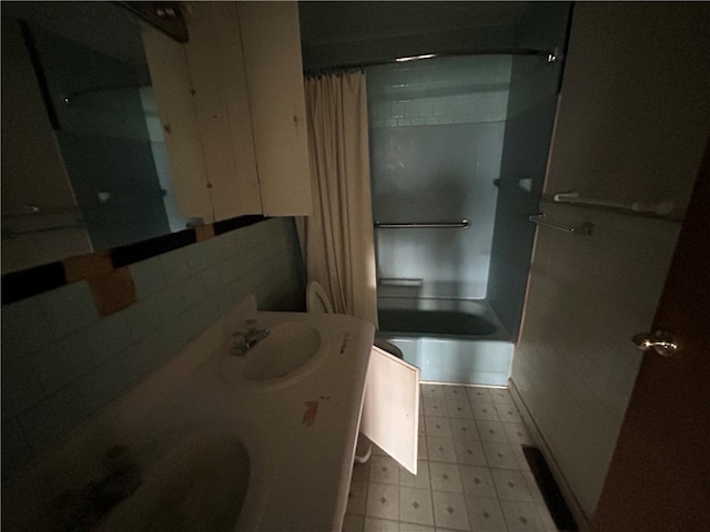 bathroom featuring shower / bath combo with shower curtain and vanity