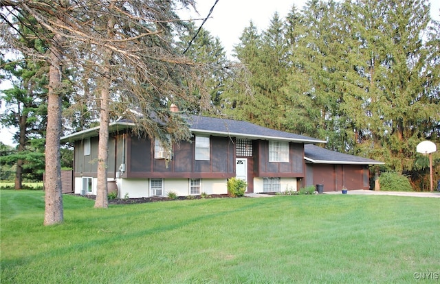 split foyer home with a front lawn