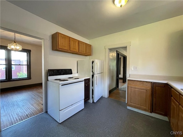 kitchen with pendant lighting, white appliances, an inviting chandelier, and dark wood-type flooring