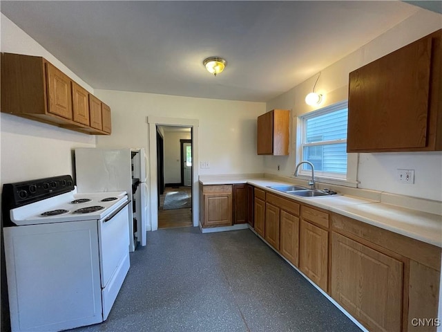 kitchen with white range with electric stovetop and sink