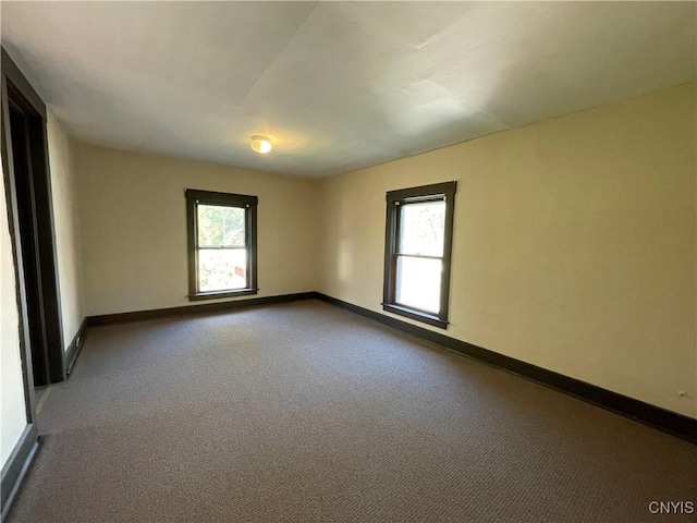 carpeted empty room featuring a healthy amount of sunlight