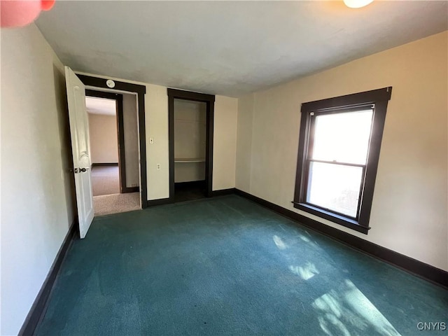 unfurnished bedroom featuring dark carpet