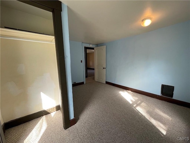 unfurnished bedroom with carpet floors and a closet