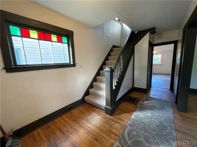 stairway with hardwood / wood-style floors