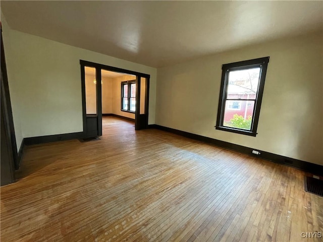 empty room featuring hardwood / wood-style flooring and a healthy amount of sunlight