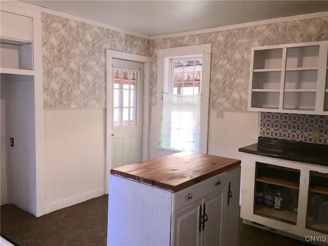 6179 State Highway 29a, Stratford, NY 13329 - kitchen with butcher block counters, open shelves, ornamental molding, and a wainscoted wall