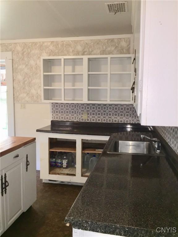 6179 State Highway 29a, Stratford, NY 13329 - kitchen with open shelves, decorative backsplash, wooden counters, and white cabinetry