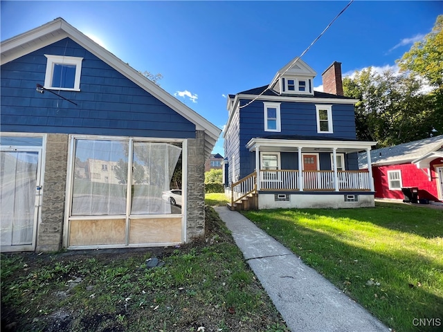 exterior space featuring covered porch and a lawn