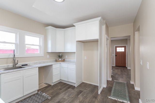 kitchen featuring a wealth of natural light, sink, and white cabinetry