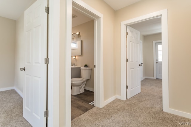 hallway with light colored carpet