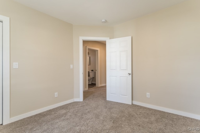 unfurnished room with light colored carpet