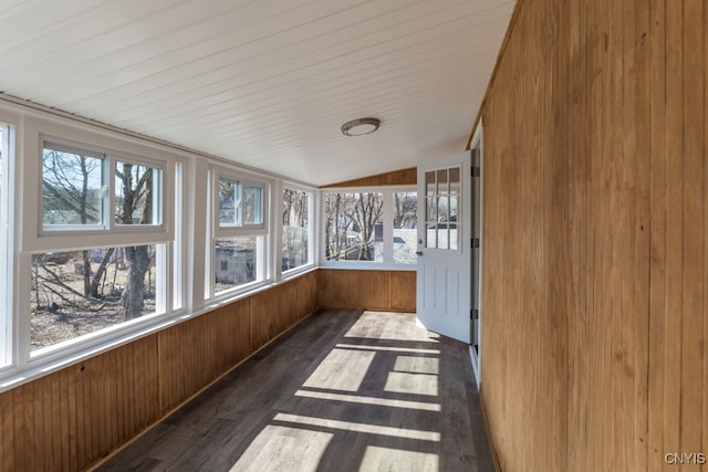 unfurnished sunroom featuring lofted ceiling and a healthy amount of sunlight