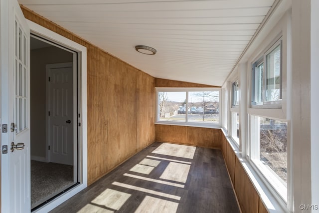 unfurnished sunroom featuring vaulted ceiling