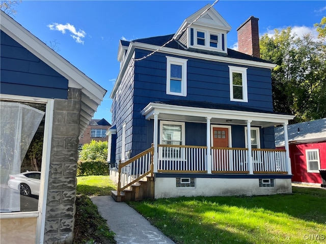 view of front of home featuring a porch and a front lawn