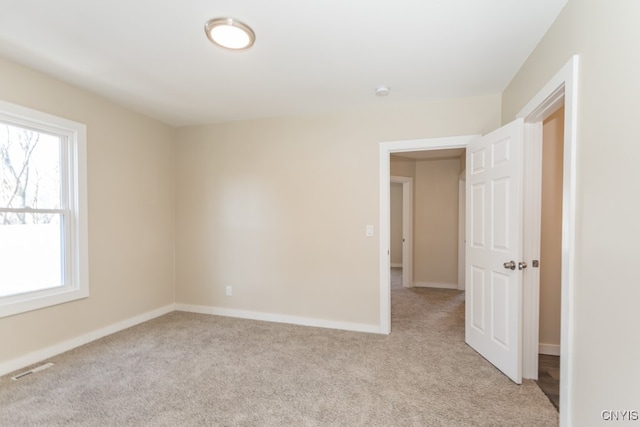 unfurnished room with light carpet