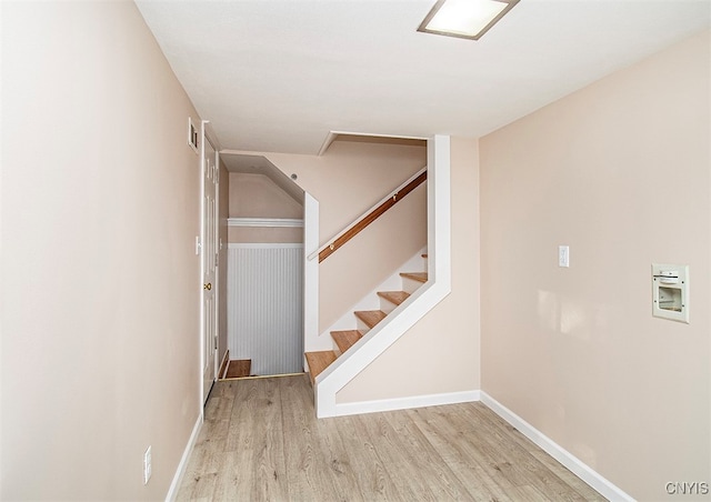 stairs featuring hardwood / wood-style floors