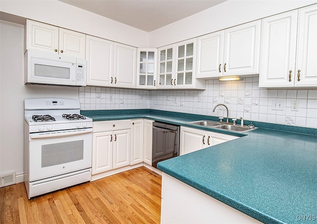 kitchen featuring light hardwood / wood-style floors, white appliances, sink, decorative backsplash, and white cabinetry