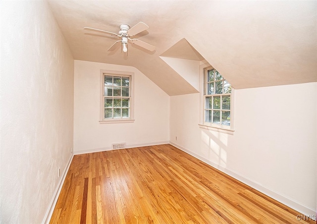 bonus room with vaulted ceiling, light hardwood / wood-style flooring, and ceiling fan