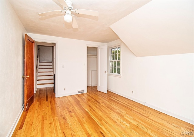 additional living space with ceiling fan, lofted ceiling, and light hardwood / wood-style floors