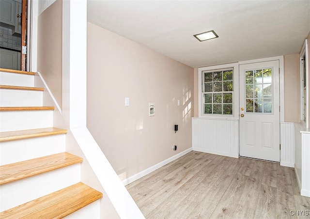 laundry room with hookup for an electric dryer and light hardwood / wood-style flooring