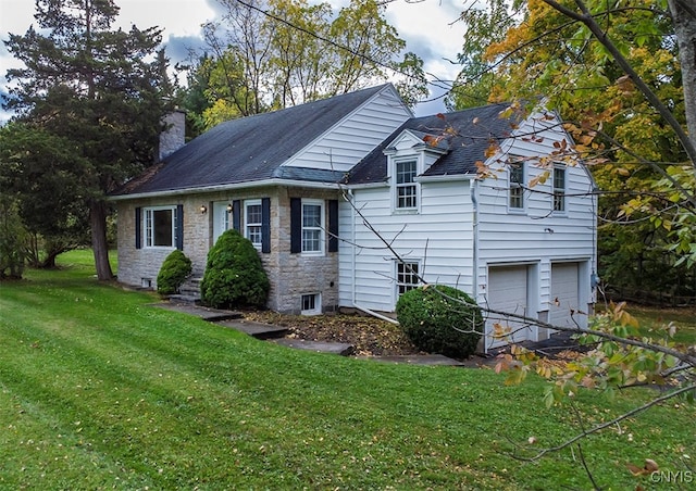 view of side of property with a garage and a yard