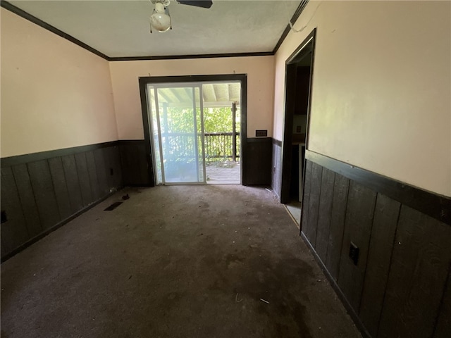 interior space with ornamental molding, carpet flooring, and ceiling fan