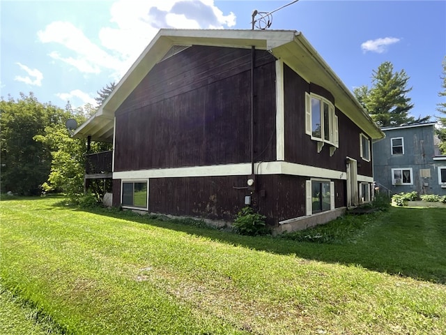 view of property exterior with a lawn