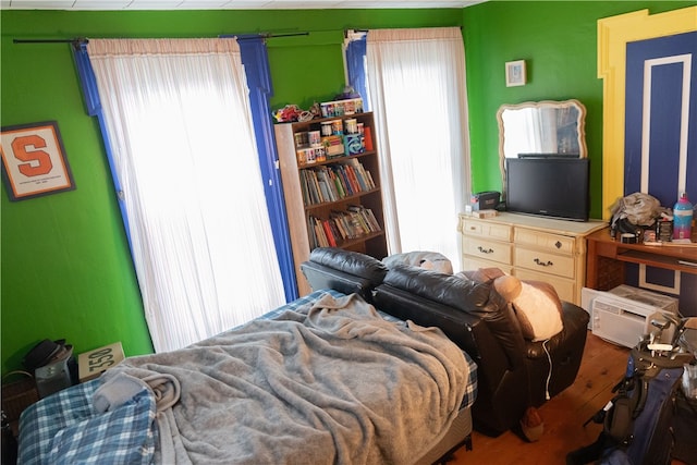 bedroom featuring hardwood / wood-style flooring and multiple windows