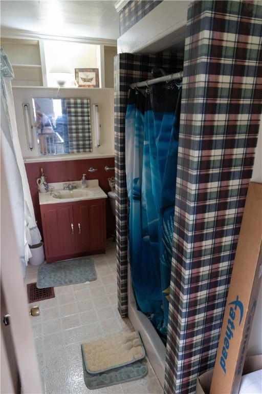 bathroom with walk in shower and vanity