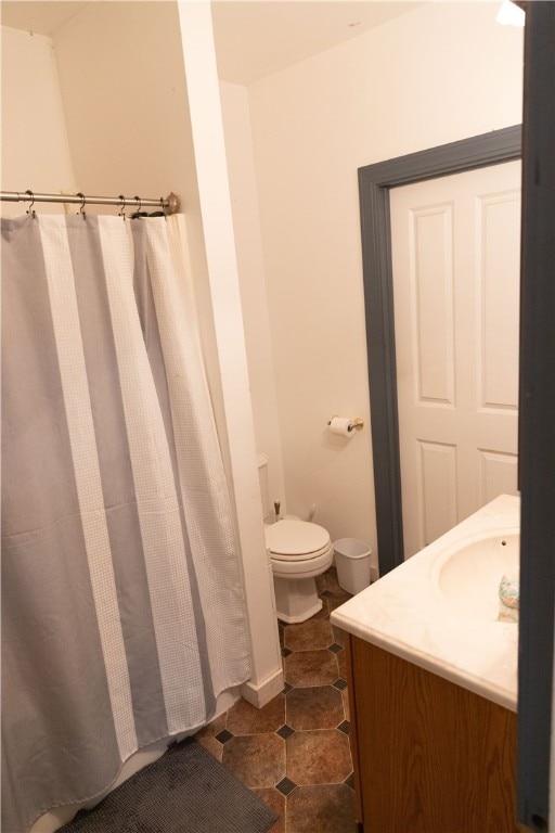 bathroom with vanity, tile patterned flooring, toilet, and curtained shower