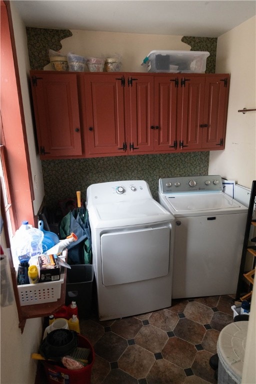 laundry room with cabinets and washer and clothes dryer