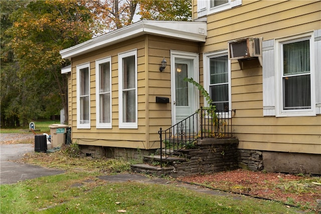 view of side of property with an AC wall unit