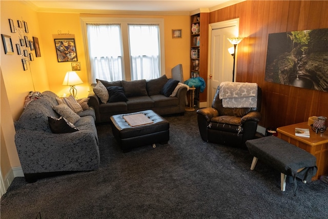 carpeted living room with ornamental molding and wooden walls