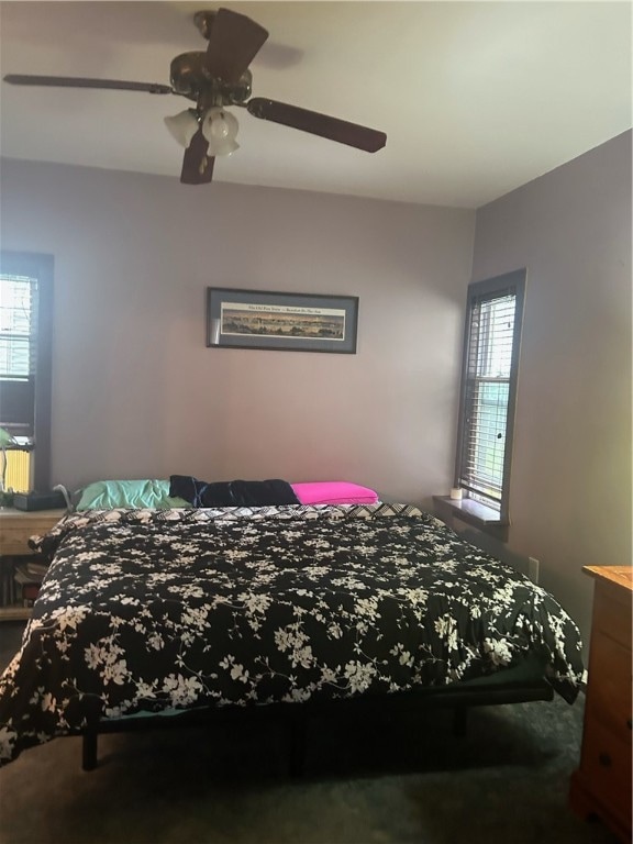 bedroom featuring multiple windows and ceiling fan