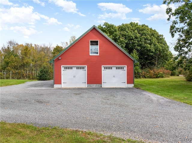 garage featuring a lawn