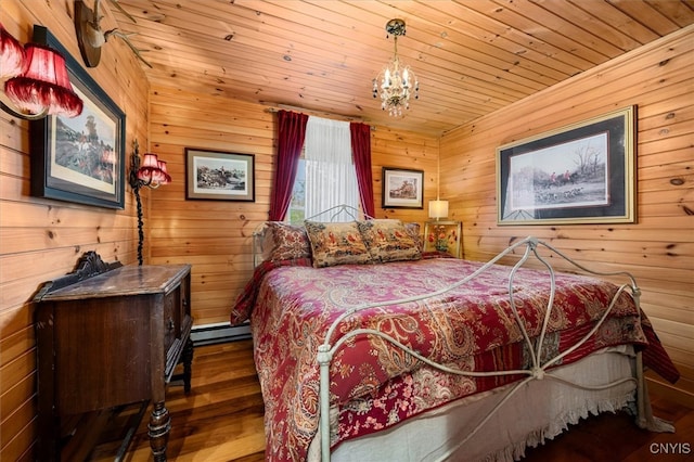 bedroom with wood walls, wooden ceiling, an inviting chandelier, wood-type flooring, and a baseboard radiator