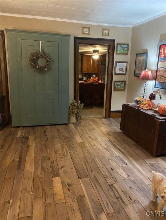 entryway featuring ornamental molding and hardwood / wood-style floors