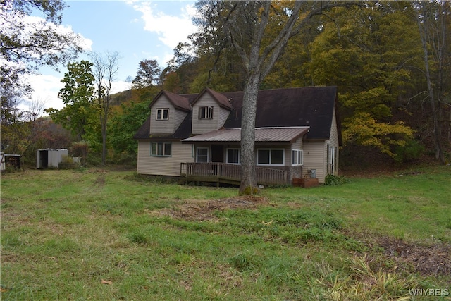 back of property featuring a storage shed and a yard