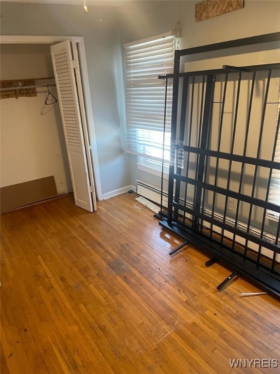 unfurnished bedroom featuring a closet and hardwood / wood-style floors