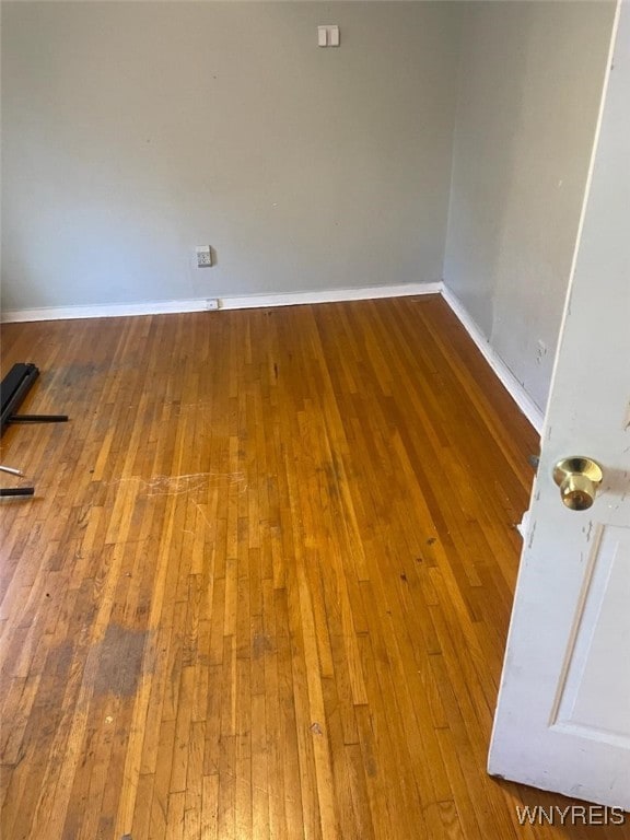 empty room with hardwood / wood-style flooring