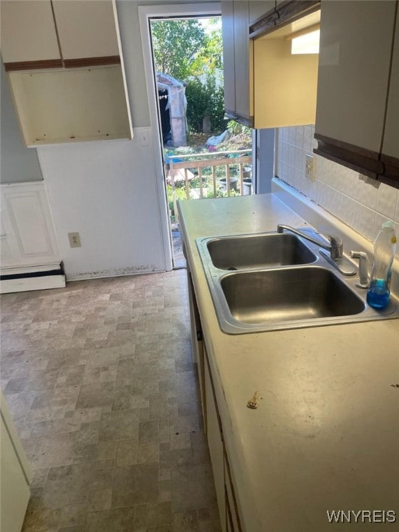 kitchen featuring tasteful backsplash and sink