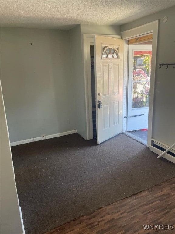 entryway with a textured ceiling and dark hardwood / wood-style floors