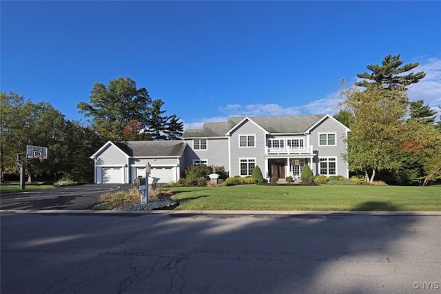 view of front of home with a garage and a front lawn