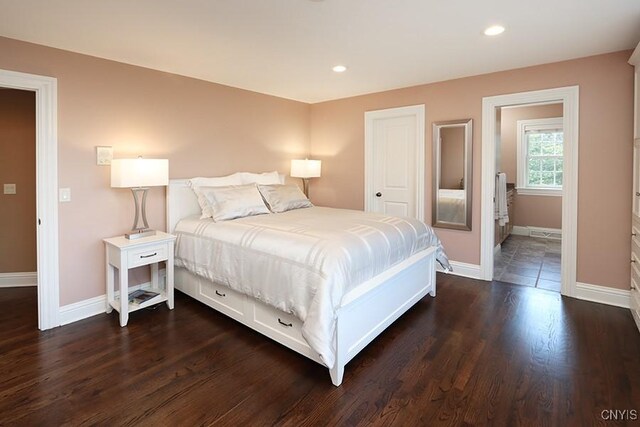 bedroom with dark hardwood / wood-style floors and ensuite bathroom