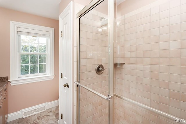 bathroom featuring an enclosed shower and vanity