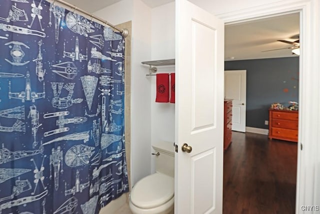 bathroom with toilet, ceiling fan, a shower with curtain, and hardwood / wood-style flooring